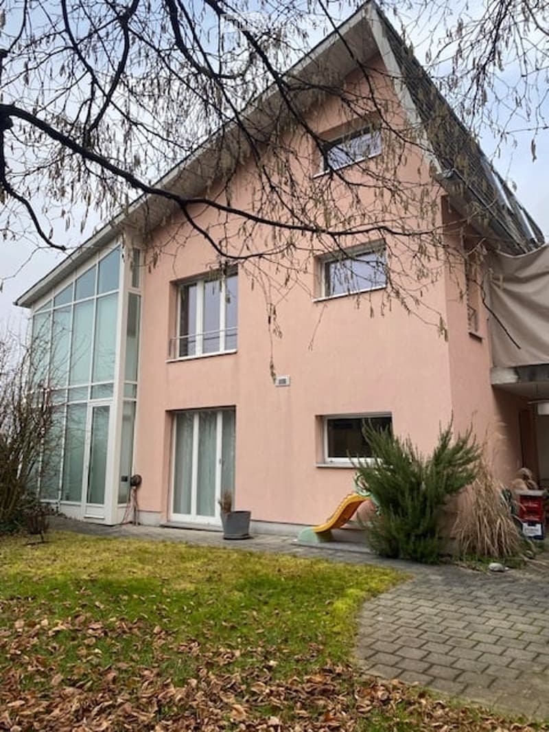 two story house, pink paint, glass windows, grass in front
