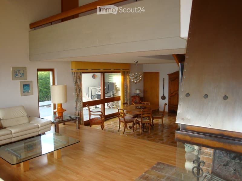 wooden floor, fireplace, large windows, balcony, sofa, coffee table, dining table, chairs, chandelier, lamp, rug
