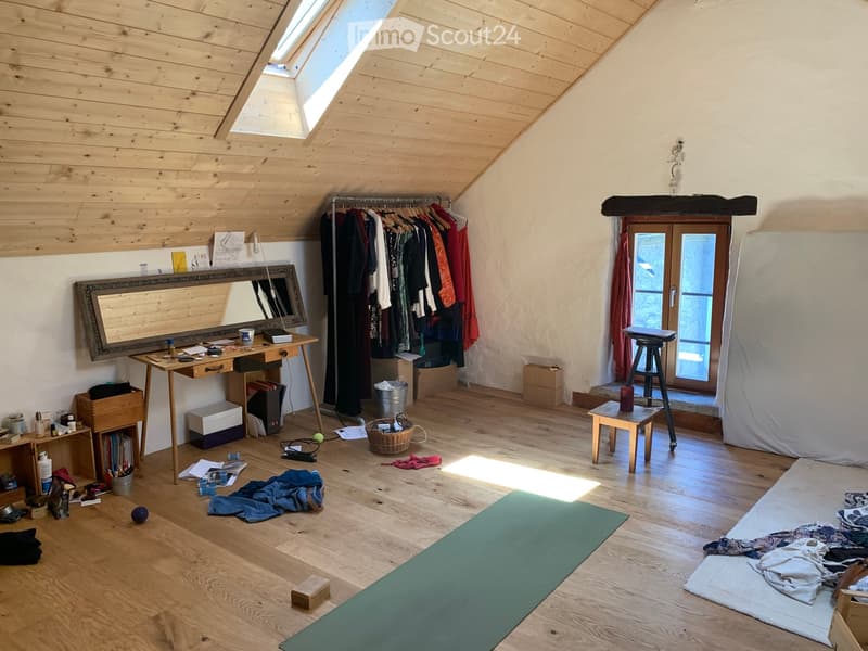 wooden floor, wooden ceiling, desk, mirror, yoga mat, clothes rack, storage boxes, stool, window