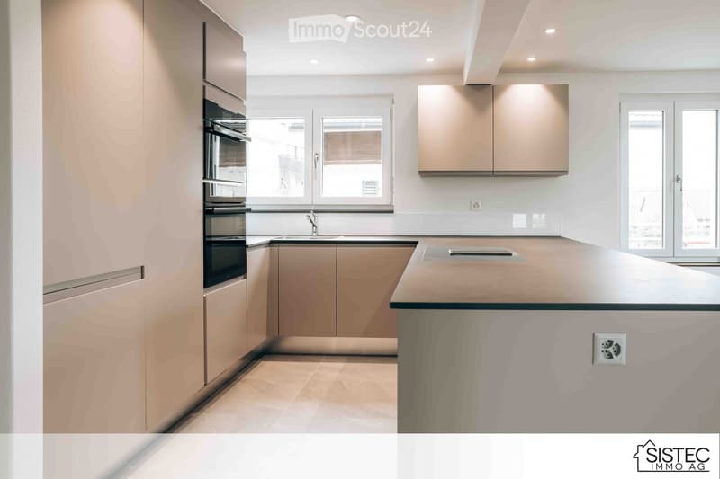 modern cabinetry, double oven, under cabinet lights, sink, island countertop