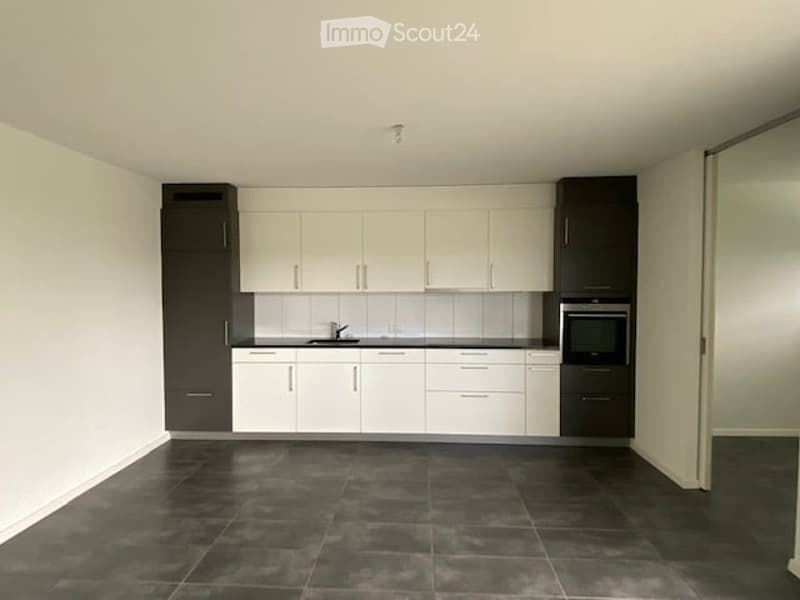 Kitchen. Modern kitchen with white cabinets, black accents, and dark tiled flooring.