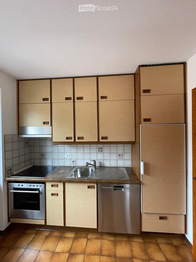 Kitchen. Modern kitchen with light wood cabinets, stainless steel appliances, and a tiled backsplash.