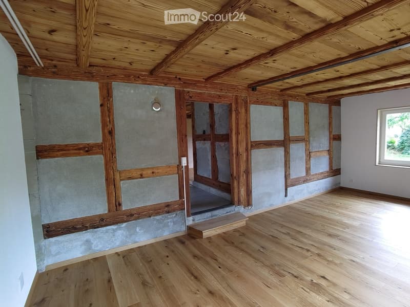 Unfurnished Room. Empty room with wooden beams, concrete walls, wooden floor, and a small window.