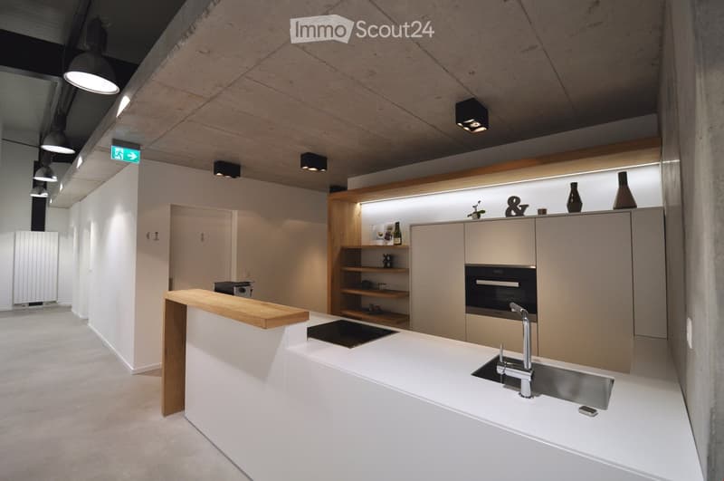 Kitchen. Modern kitchen with white cabinets, stainless steel sink, built-in oven, and wooden countertop.