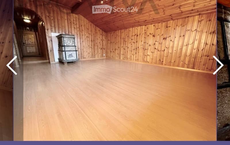 Unfurnished Room. Empty room with wooden walls and floor, featuring a small decorative chest in the corner.