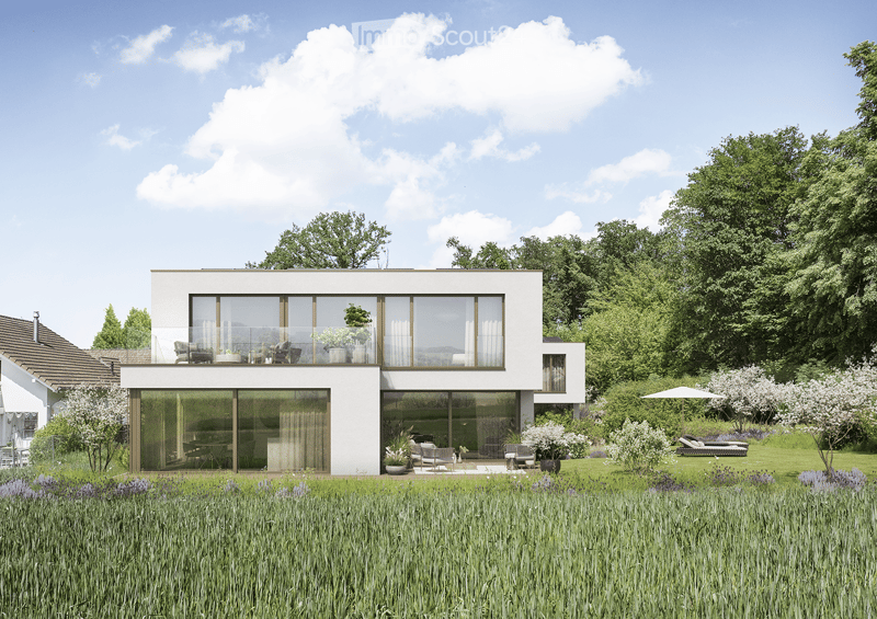 House. Modern two-story house with large glass windows and a raised ground floor, surrounded by a well-maintained garden with lawn, trees, and outdoor seating.