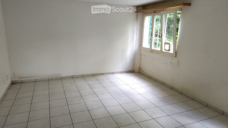 Unfurnished Room. Empty room with tiled floor and white walls, featuring a single window with white frame and glass panels.