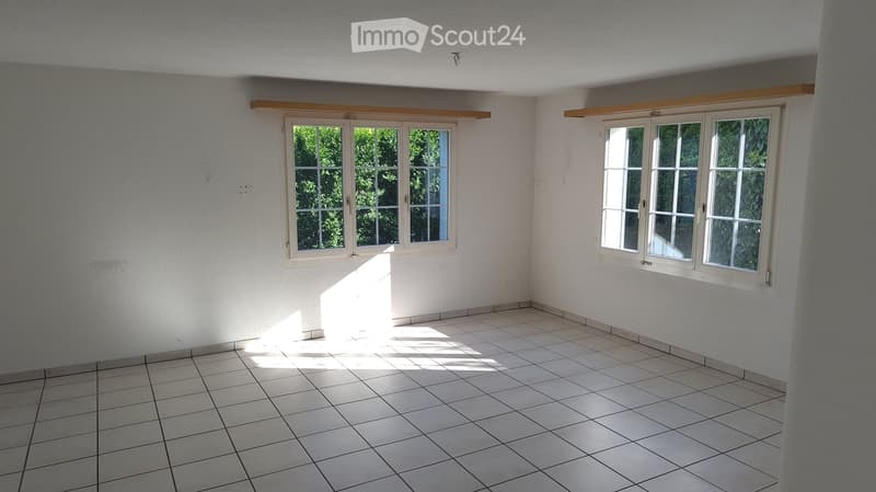 Unfurnished Room. Empty room with white tiled flooring and white walls, featuring two large windows with white frames and wooden sills, allowing natural light to enter.