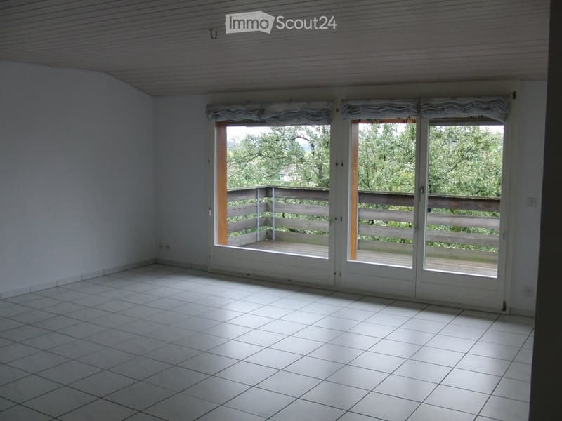 Unfurnished Room. Empty room with white tiled floor, large sliding glass doors leading to a wooden deck, and white walls.
