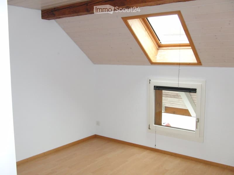 empty room, wooden floor, slanted ceiling, window, skylight