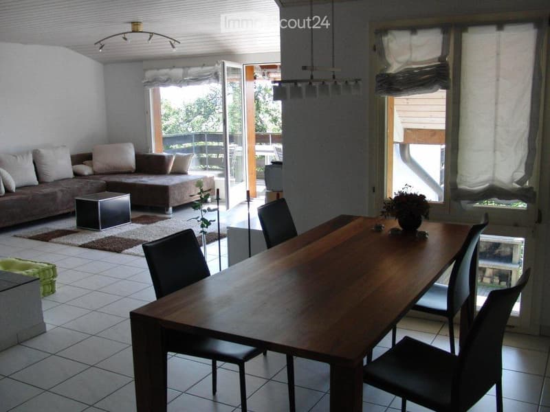 living room with couch, dining table with 4 chairs, open sliding door to balcony, white walls, carpet