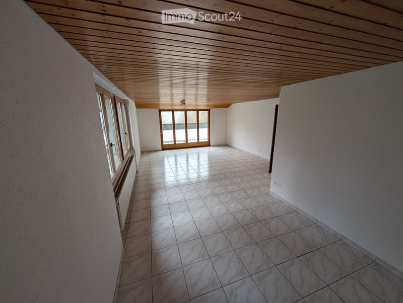 Unfurnished Room. Empty room with tiled floor, wooden ceiling, and large windows, including a sliding glass door.
