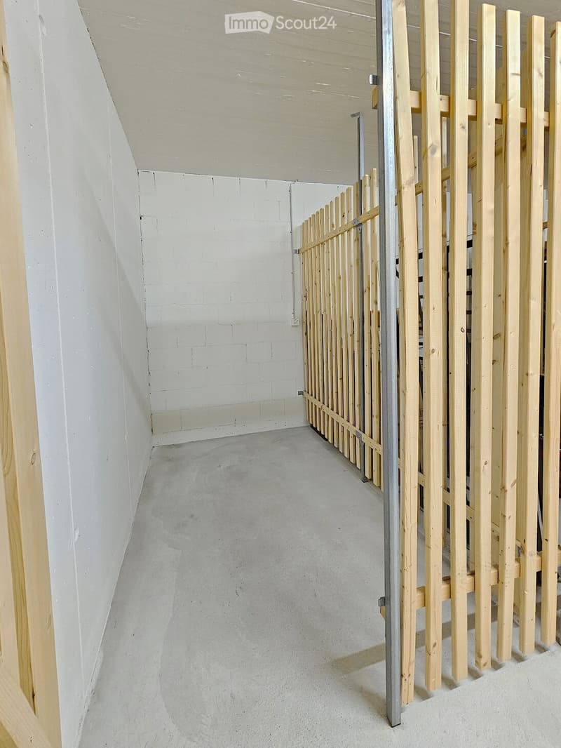 Unfurnished Room. Empty room with white brick walls and concrete floor, featuring wooden planks and a metal frame structure.