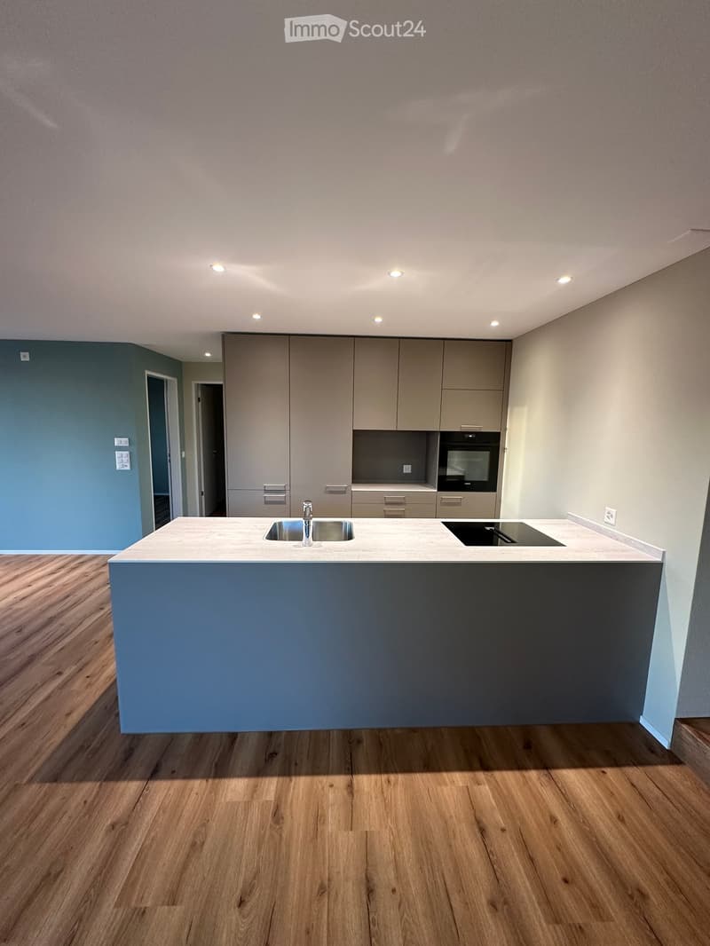 Kitchen. Modern kitchen with a central island, stainless steel sink, built-in oven, and sleek cabinetry.