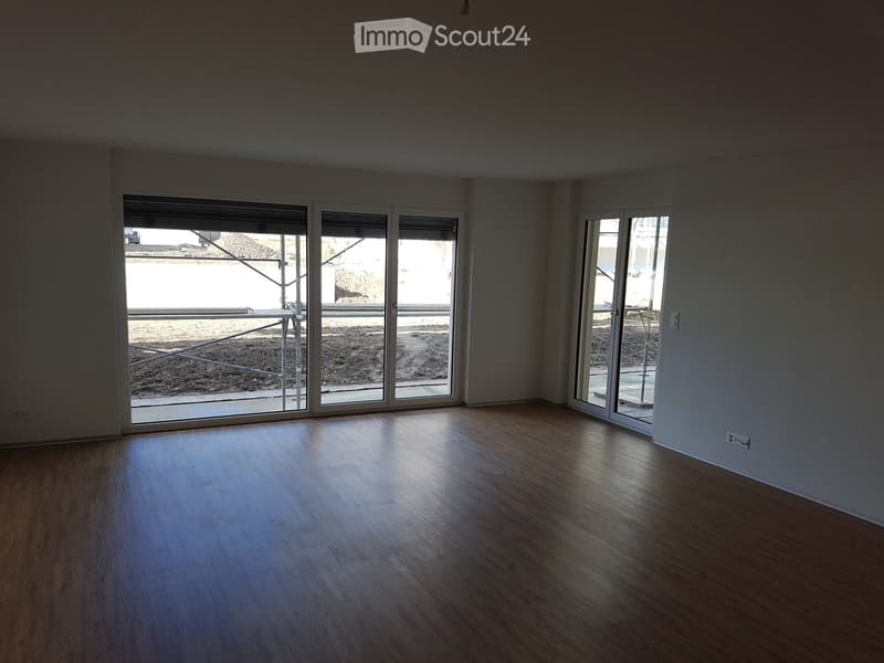 Unfurnished Room. Empty room with wooden flooring and large sliding glass doors leading to an outdoor area.