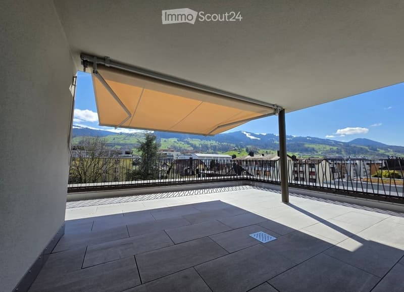 Balcony / Terrace. Balcony with tiled floor, metal railing, retractable awning, and scenic mountain view.