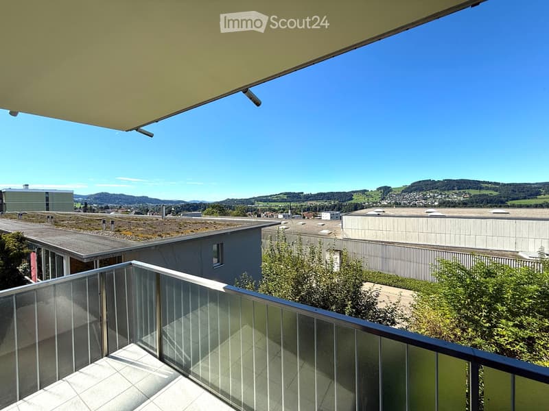 large balcony with glass railings, tiled floor, beautiful view