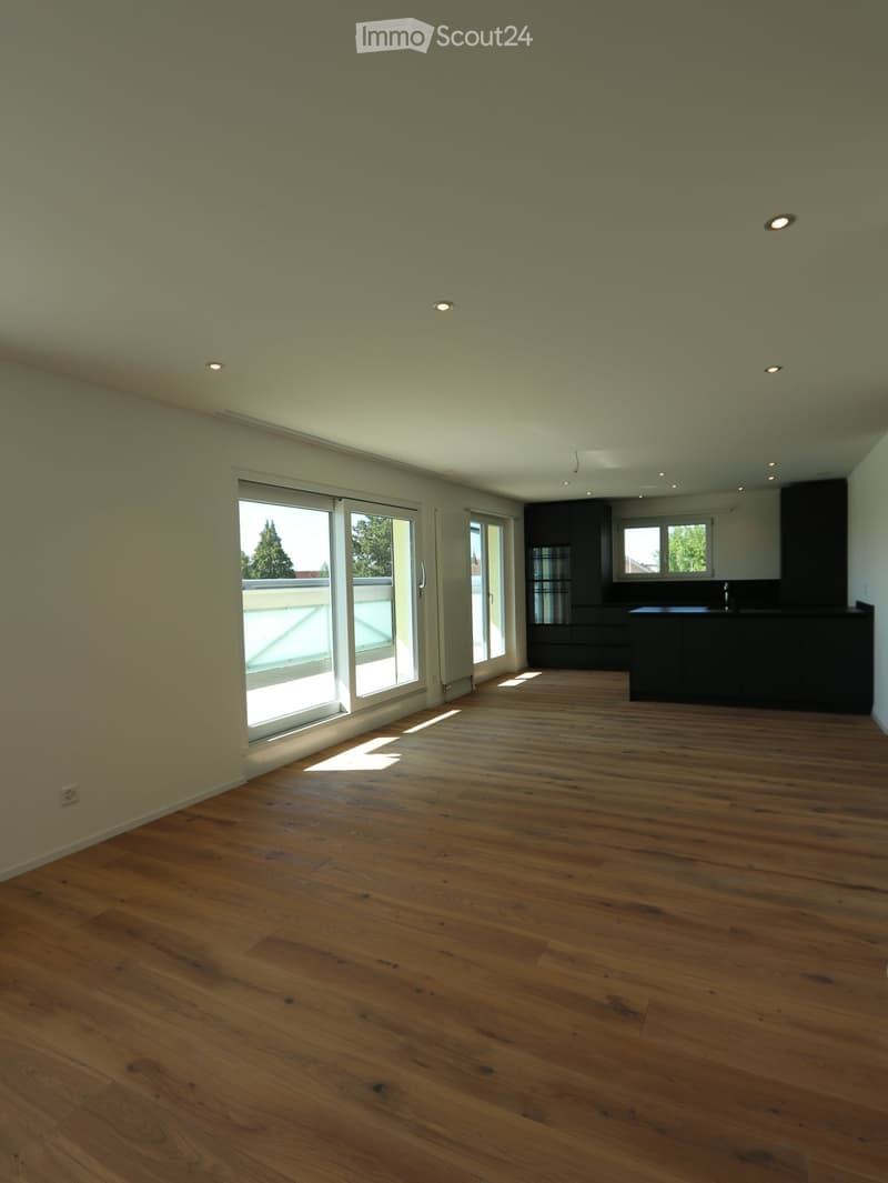 Unfurnished Room. Empty room with wooden flooring, large windows, and recessed lighting. No furniture or equipment present.