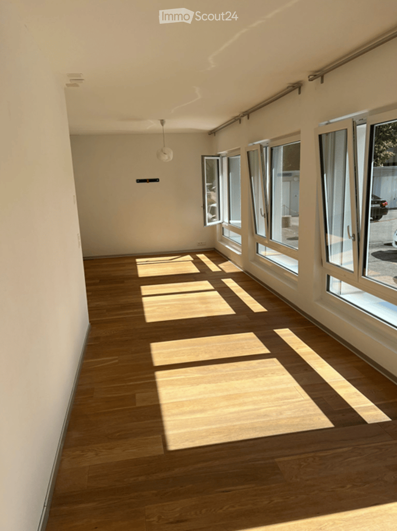 Unfurnished Room. Empty room with wooden flooring and large windows allowing natural light to enter. The space is unfurnished, showing only the basic structure and flooring.
