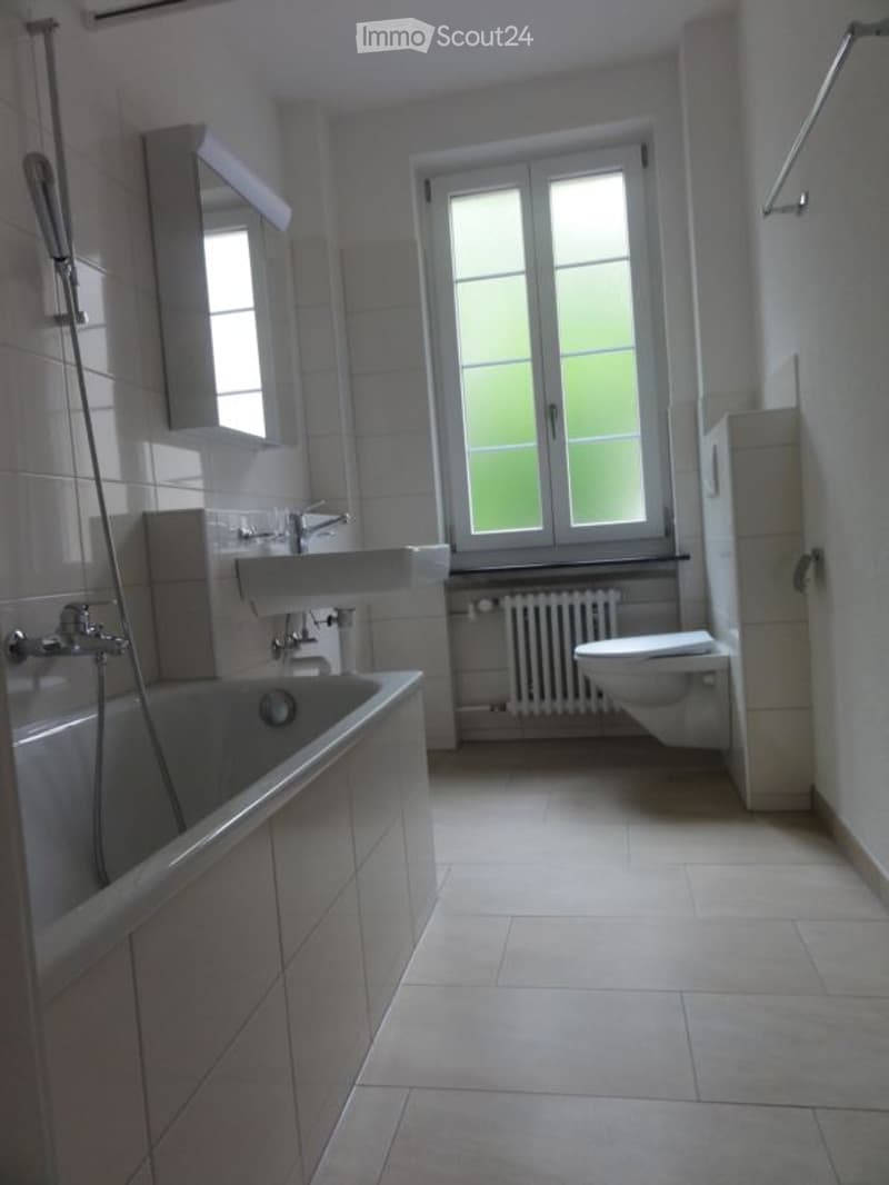 Bathroom with bathtub, sink, toilet, window, radiator, tiled floor, and shower