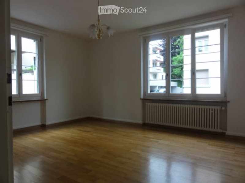 Wooden floor, large windows, chandelier, radiator