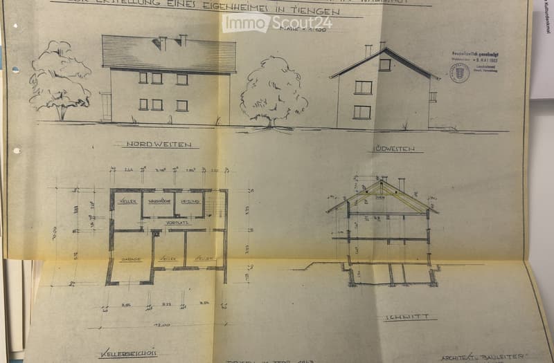 Architectural floor plan of a residential building, showing multiple rooms including a kitchen, heating room, garage, and cellar spaces. The plan includes detailed measurements and labels for various sections.