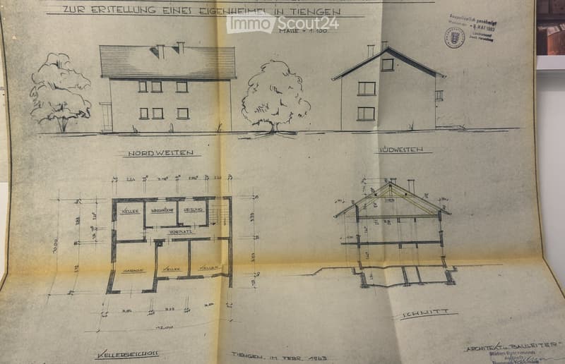 Architectural floor plan showing a house layout with labeled rooms including cellar, garage, and heating room. Includes exterior views and measurements.