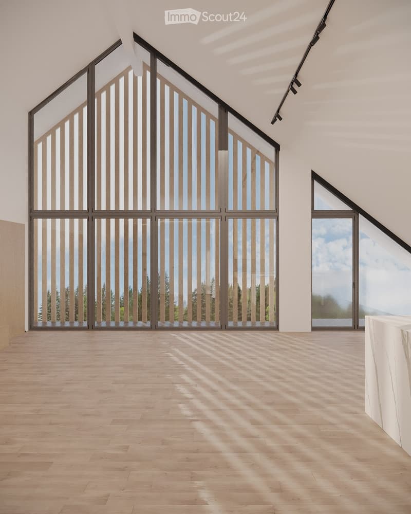 Bright, empty room with large windows and wooden flooring, featuring natural light and a minimalist design.