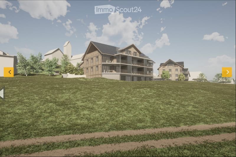 A multi-story residential building with balconies and a raised ground floor, surrounded by a grassy area and trees.
