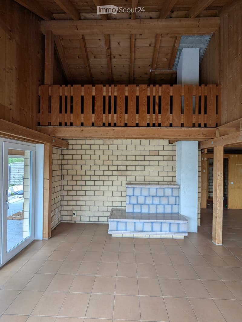 exposed wooden beams, brick wall, tiled floor, steps, balcony with wooden railing