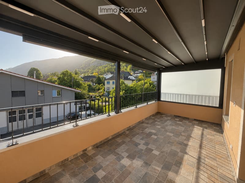 Balcony with tiled floor, metal railing, and scenic mountain view.