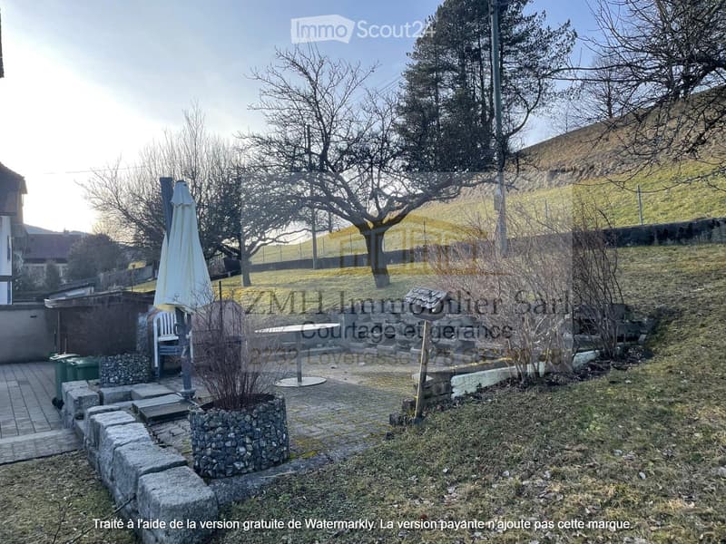 garden with paved area, table and chairs, plants, view of hills
