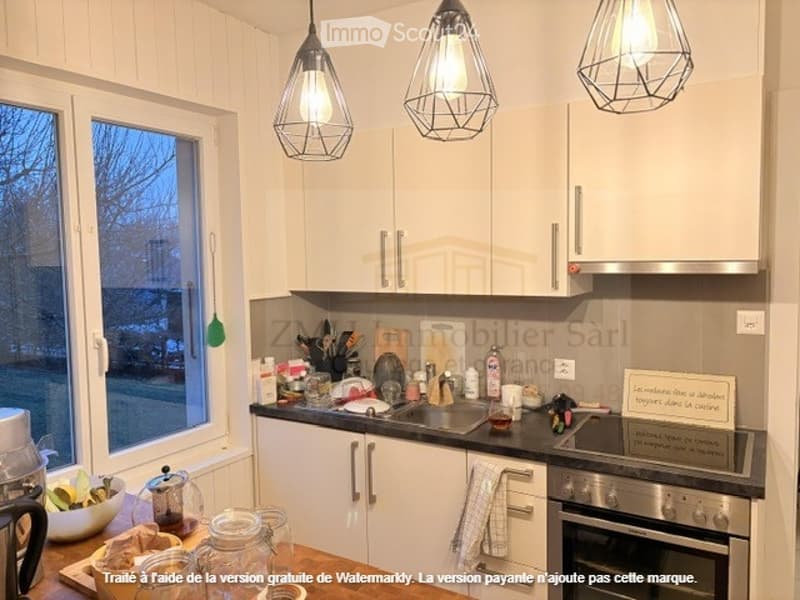 kitchen with appliances, large window, hanging lamps