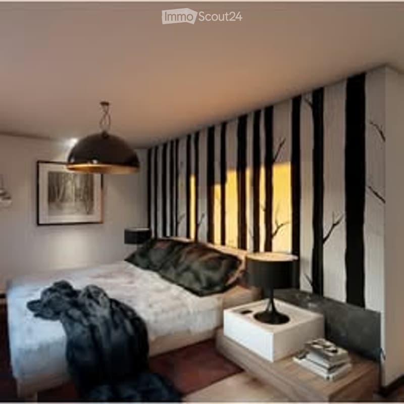 Modern bedroom with a large bed, nightstand, lamp, picture frame, and a small table with a chair. The walls are decorated with black and white striped wallpaper, and there is a hanging pendant light above the bed.