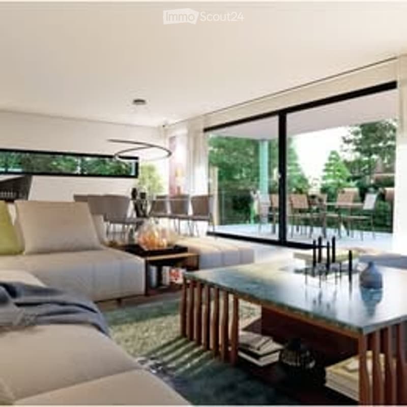 Modern living room with large floor-to-ceiling windows offering a view, a cream-colored sectional sofa, a wooden coffee table, side tables, and a floor lamp.