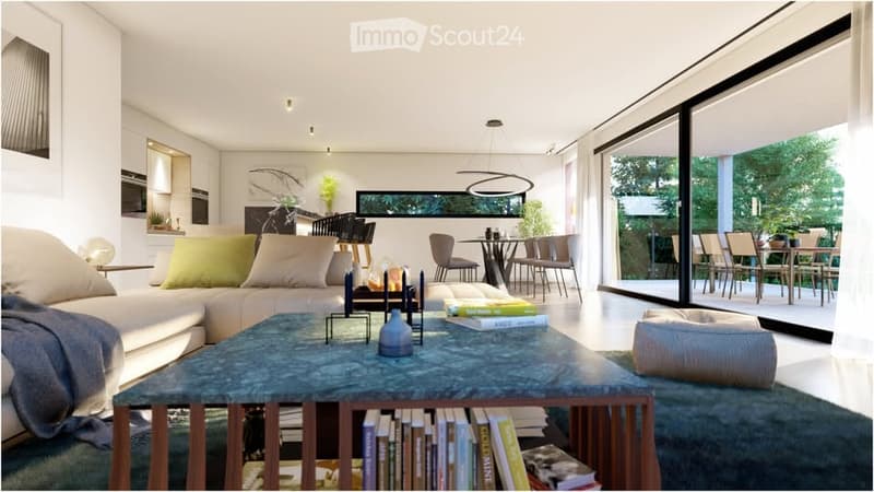 Modern living room with a large sectional sofa, coffee table, books, dining area with table and chairs, and large windows offering a view of greenery.