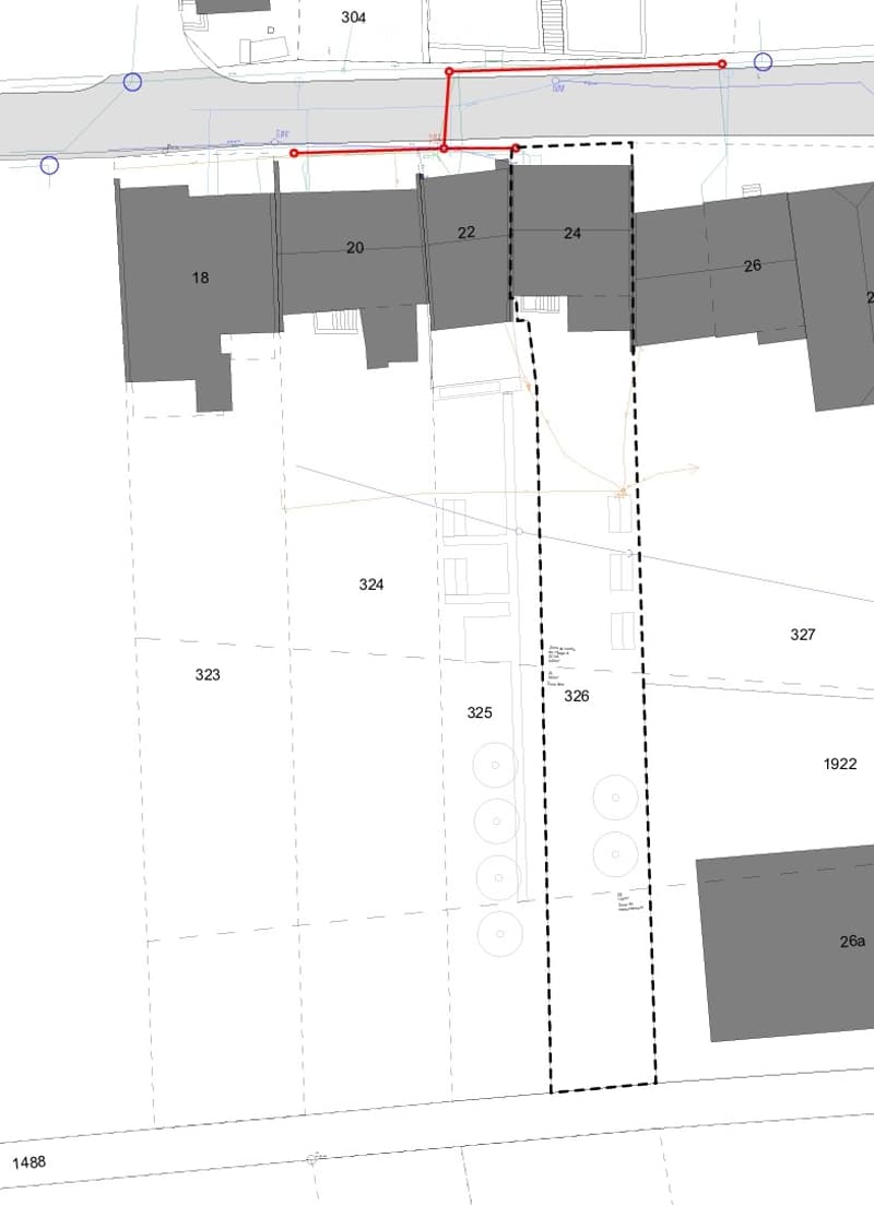 Floor plan showing multiple labeled areas including rooms and parking spaces, with numbered sections and a highlighted boundary in red.