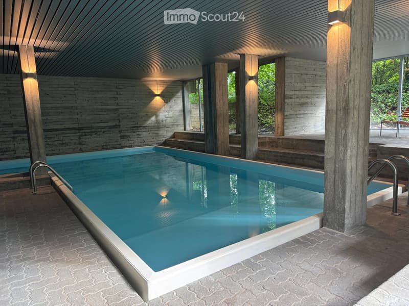 Garden / Outdoor Area. Modern outdoor swimming pool with wooden beams, steps, and a serene setting surrounded by greenery.
