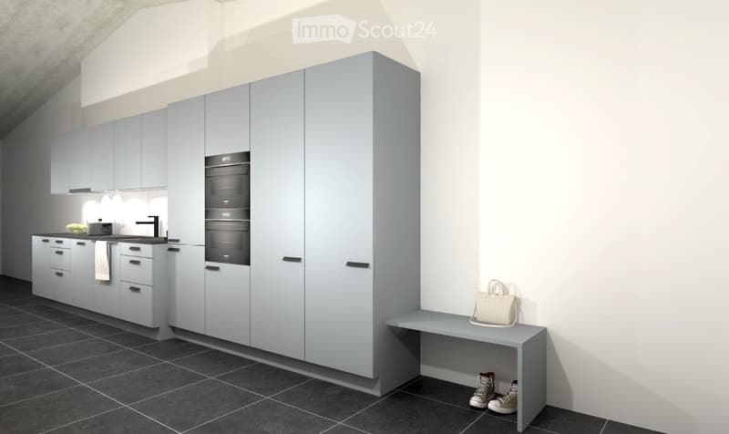 Modern kitchen with grey cabinets, built-in oven, sink, and a small bench with a handbag and shoes nearby.