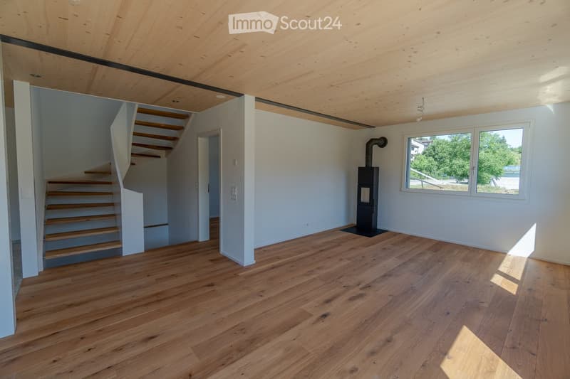 wooden flooring, open staircase, fireplace, big window, white walls
