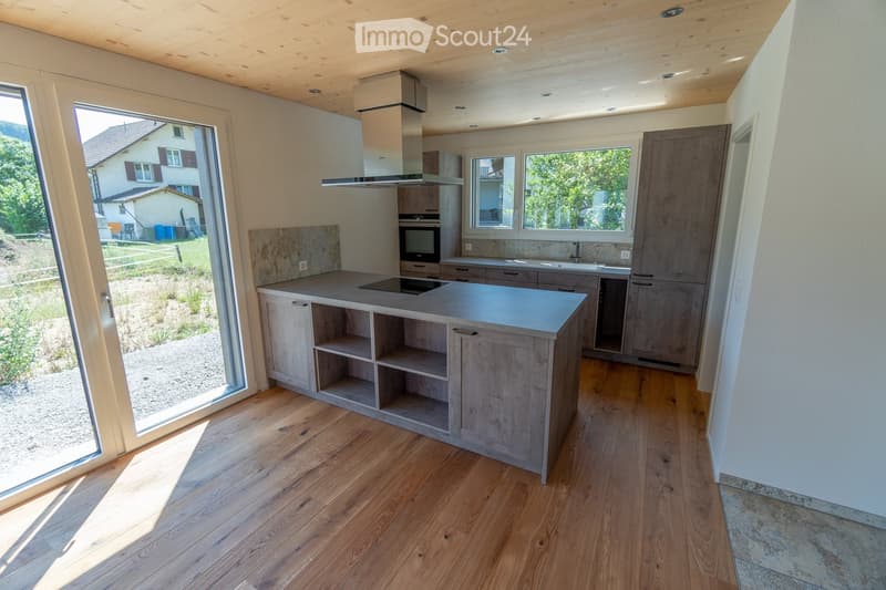 modern kitchen, island with countertop, sink, stove and oven, sliding glass doors, wooden floor, white walls