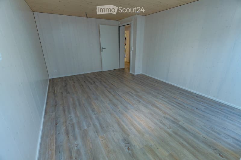 empty room, wooden floor, white walls, open door leading to another room