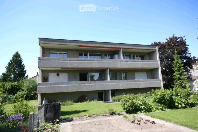 3 story apartment building, balconies, garden, trees