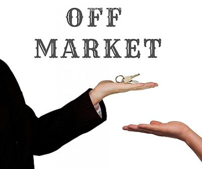 Image shows a hand holding a set of keys with the text "OFF MARKET" above it, indicating a property is no longer available for sale.