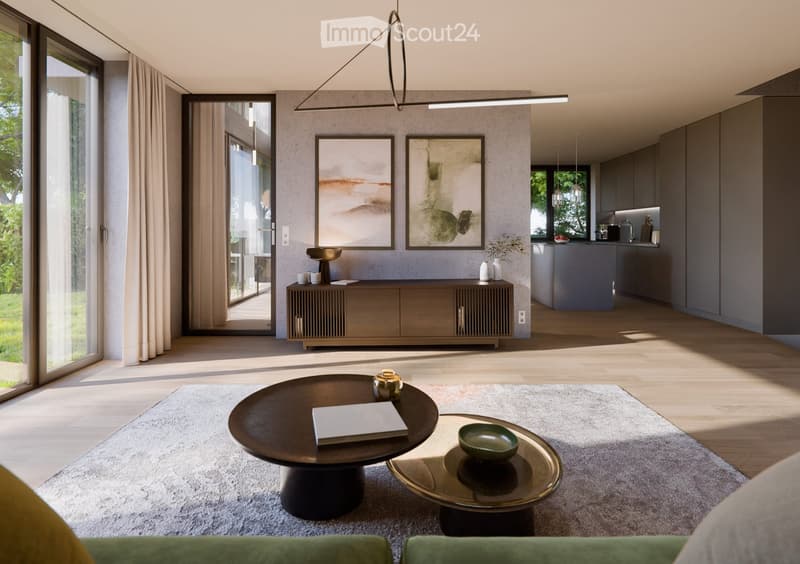 Modern living room with a grey sofa, dark wooden coffee table, side table, and a grey cabinet. The room features large windows with curtains, a sleek pendant light, and a view of the kitchen area.