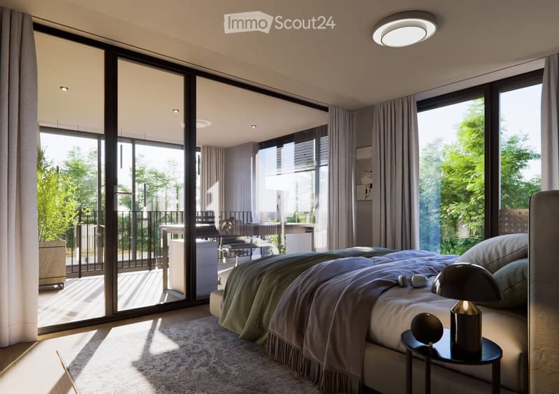 Modern bedroom with large windows and sliding glass doors leading to a balcony, featuring a bed, nightstand, and lamp.