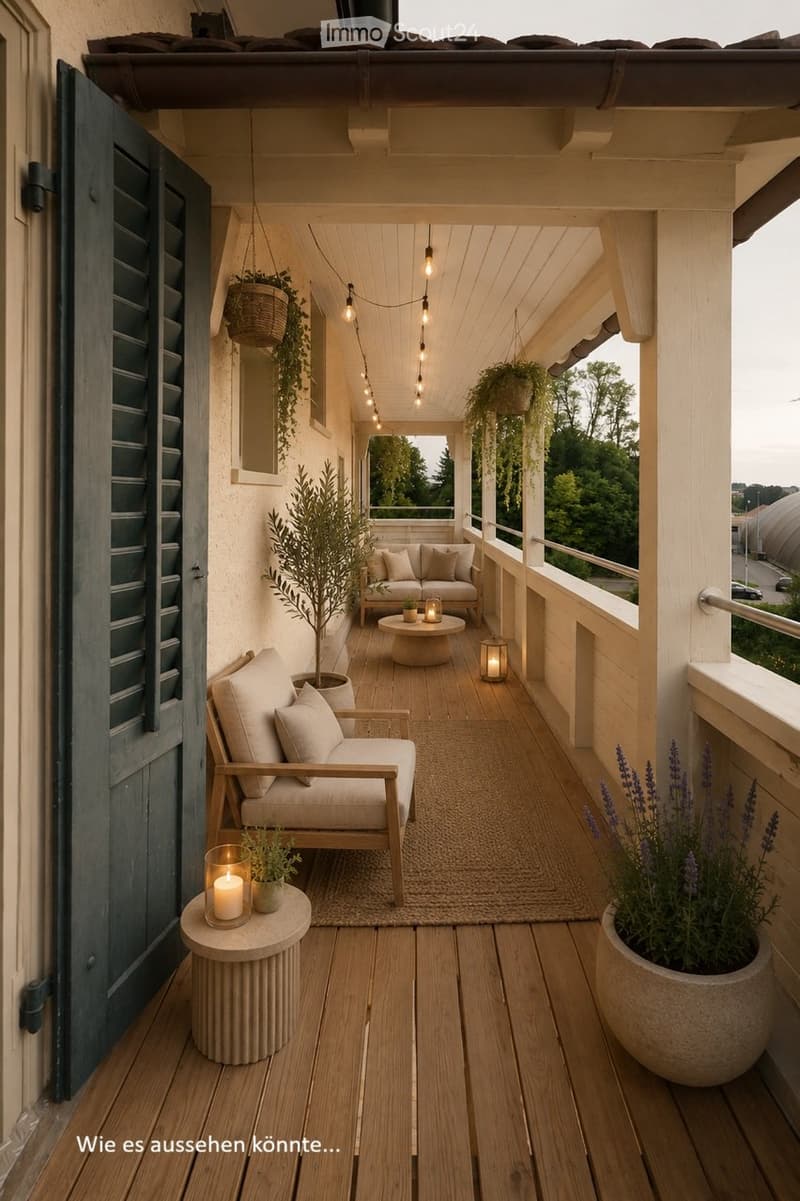 Cozy balcony with wooden decking, white wooden columns, hanging lights, potted plants, and seating area with a sofa and small tables.