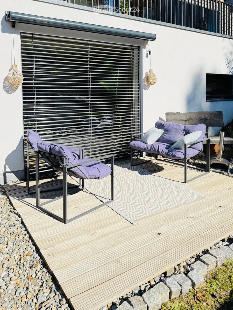 covered patio, modern metal chairs, white rug, purple pillows