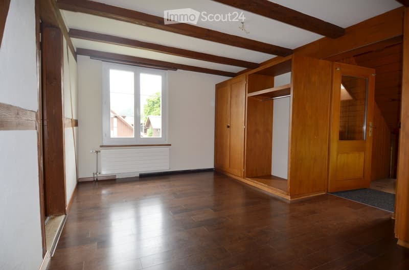 empty room, wooden floor, white walls, wooden beams, window, built-in wardrobe