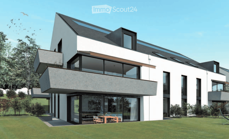Modern two-story house with white and grey exterior, large windows, and balconies. The house features a raised ground floor and a spacious lawn in front.